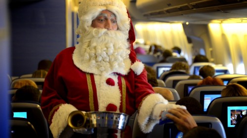 Santa in Economy Class. KLM's Happy Holidays Flight: Surprising Travelers Again. - by ViralBlog.com 